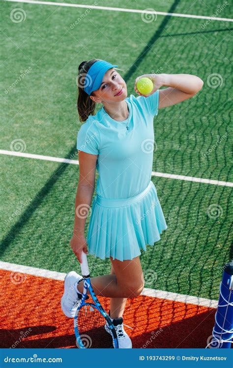 Smiling Teenage Girl Posing With Ball In Her Hand On A Tennis Court Royalty Free Stock