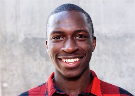 Smiling Face Of Young African Man Stock Photo By Mimagephotography