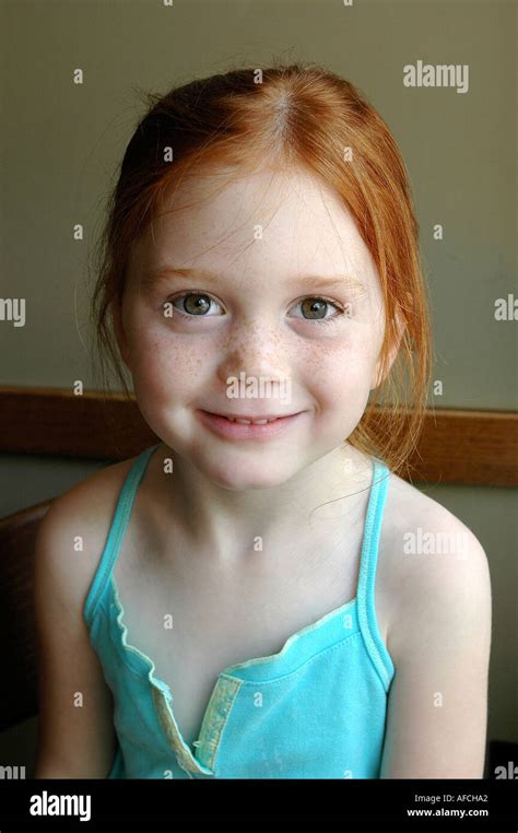 Portrait Of Irish American Redhead Cute 5 Five Year Old Young Girl With Hazel Green Eyes Smiling