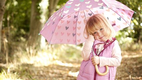 Cute Little Girl Is Under Umbrella Wearing Pink Dress