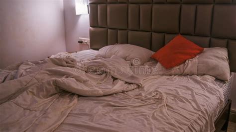 An Empty Rumpled Bed In The Hotel Crumpled Blanket And Pillows Close Up Of Messy Bed Used