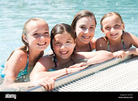 Group Of Girls On The Edge Of A Public Swimming Pool Stock Photo Alamy
