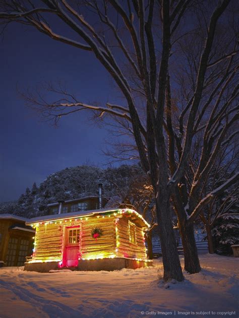 Log Cabin Decorated With Christmas Lights In Snow At Night Decorating