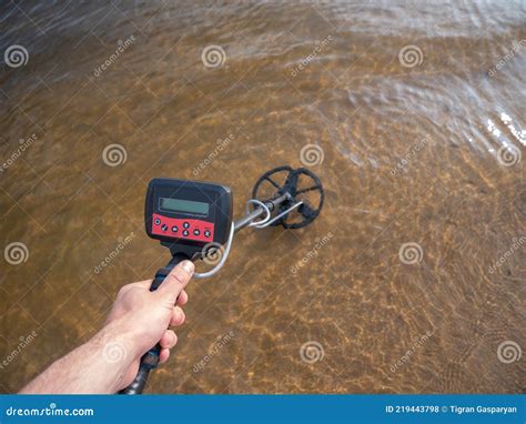 Close Up Of A Metal Detector Submerged In Water Stock Photo Image Of