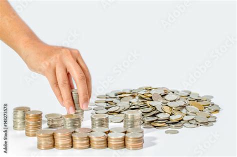 Hand Of Woman Putting Coin To Rising Stack Of Coins Saving Money