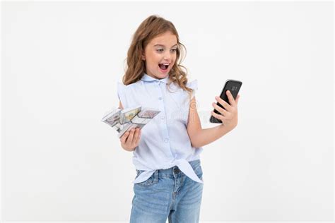 Happy Teenager Girl Holding Money On A White Background With Copy Space