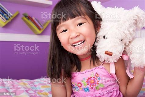 Smiling Asian Girl Hugging Teddy Bear In Bed Stock Photo Download