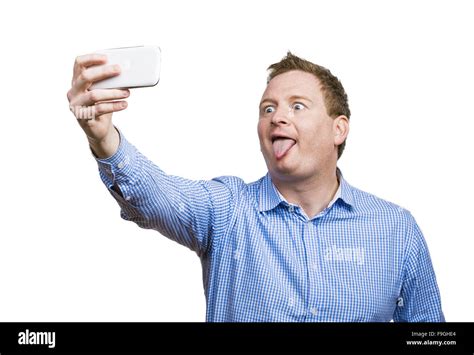 Man Making Funny Faces While Taking Selfie Of Himself Studio Shot On