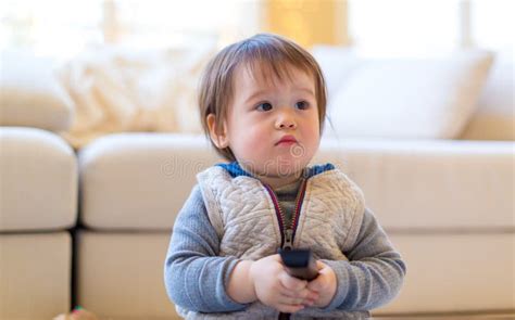 Toddler Boy Watching Tv With A Remote Control Stock Photo Image Of