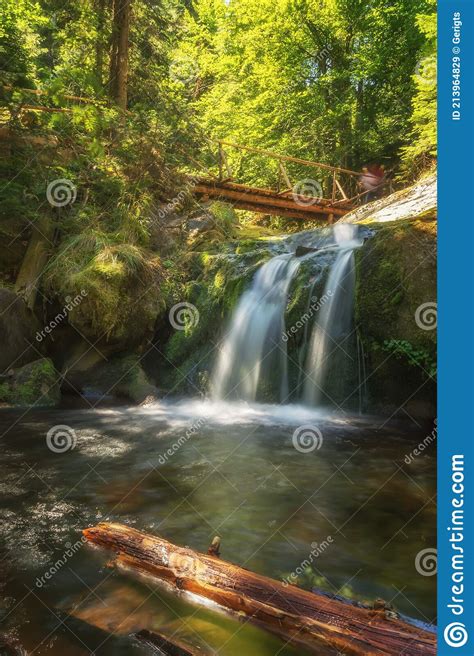 Bubbling Foamy Waterfalls Under Wooden Bridge Stock Image