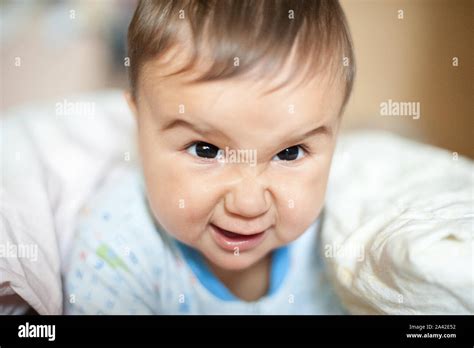 Portrait Of Baby Boy Angry Furious Frowning And Agressive Lying On