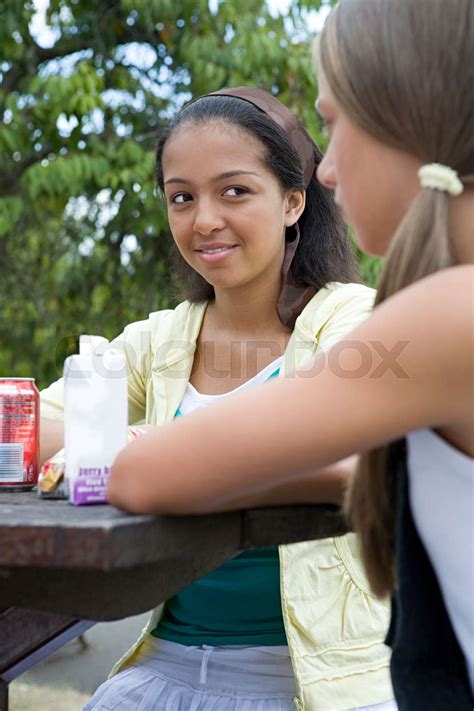 Teenage Girls At Picnic Table Stock Image Colourbox