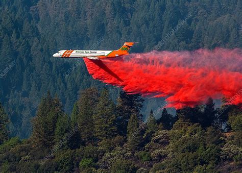 Aircraft Releases Fire Retardant Over Forest Fire Stock Image C032
