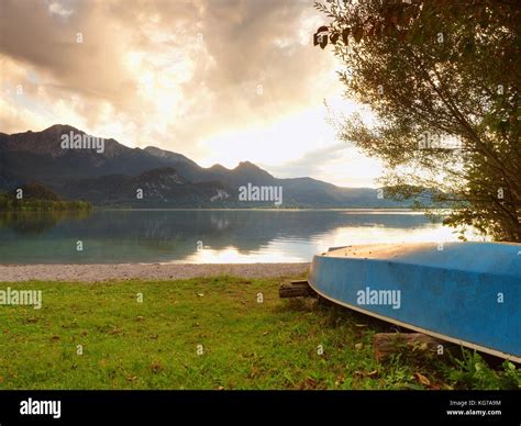 Upside Down Fishing Paddle Boat On Bank Of Alps Lake Smooth Levelof
