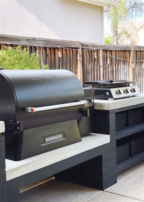 Black Traeger Grill And A Stove Top Placed On A Black And White Custom