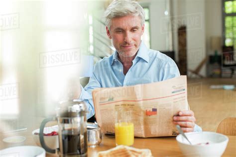 Check spelling or type a new query. Older man reading newspaper at breakfast table - Stock ...