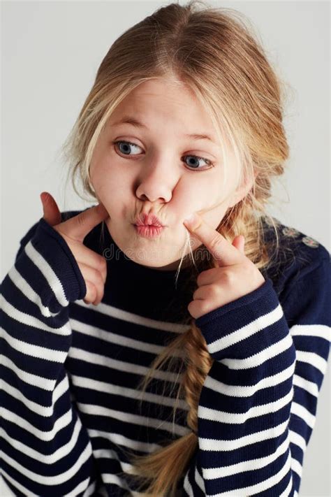 feeling quirky a cute girl pressing her cheeks with her fingers stock image image of cropped