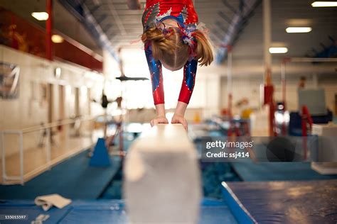 Young Gymnast Doing Handstand On Balance Beam High Res Stock Photo