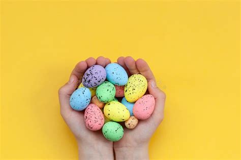 Kid`s Hands Holding Colorful Painted Easter Eggs On Yellow Background