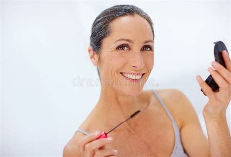 Making Her Beautiful Eyes Stand Out An Attractive Mature Woman Applying Mascara Stock Image