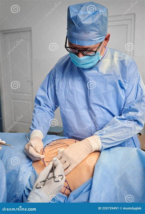 Male Doctor Doing Plastic Surgery In Operating Room Stock Image