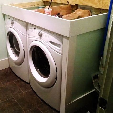 In order to support the countertop, you need something that will keep it affixed to the wall, and something to hold it above the laundry machines. DIY Laundry Room Countertop Over Washer Dryer