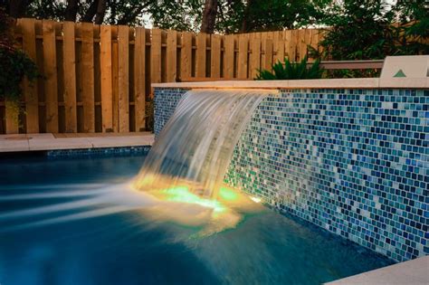 Scuppers, sheer descents and waterfalls are all examples of open pipes that need high flow rates. SHEER DESCENT | Pool waterfall, Inground pool landscaping ...
