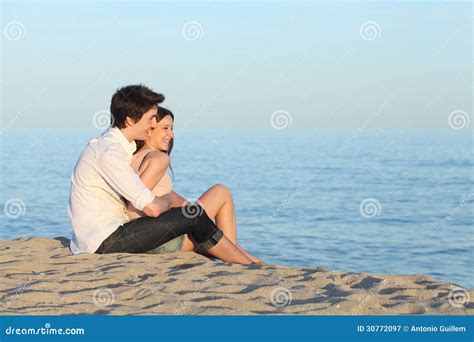 Couple Cuddling Sitting On The Sand Of The Beach Stock Image Image Of