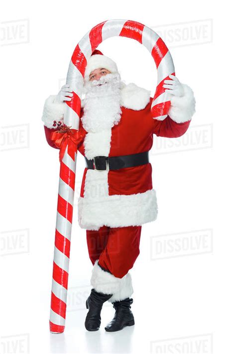 Happy Santa Claus Standing With Big Christmas Candy Cane Isolated On