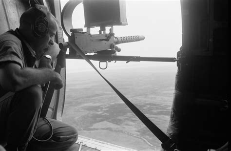 American Door Gunner Scans The Vietnamese Landscape From A Helicopter