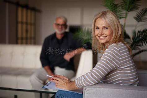 Portrait Of A Smiling Female Psychologist Help Mature People Stock