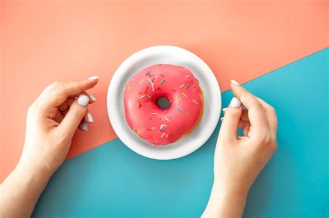 Premium Photo Female Hands And Donut On A Blue Background Flat Lay
