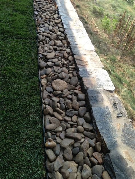 Backfill And River Stone Were Used To Finish The Top Edge Of This