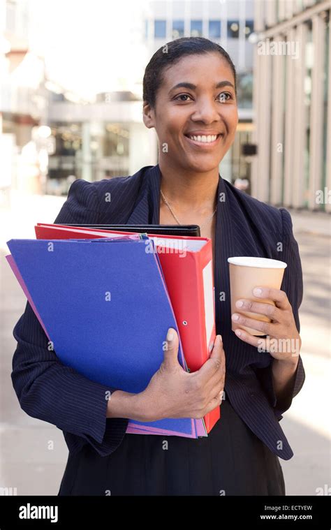 Business Woman With A Coffee And Folders Stock Photo Alamy