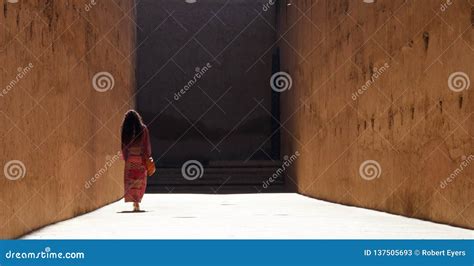 Lady Walks Away Down A High Walled Alley Stock Image Image Of