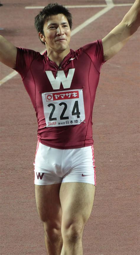 A Man In Red Shirt And White Shorts Holding His Arms Up While Standing