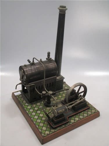 A Bing Miniature Tinplate Steam Stationary Engine On A Tiled Wooden