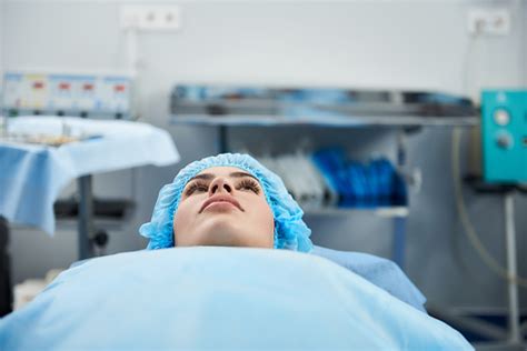 Close Up Of Young Lady Lying On The Operation Table And Waiting Stock