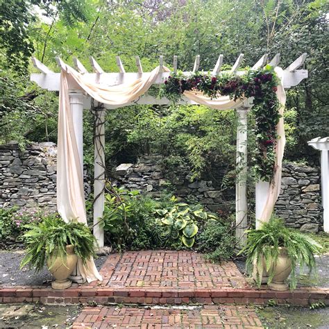 Lush Wedding Arbor With Dahlias And Greenery Wedding Flowers Florist