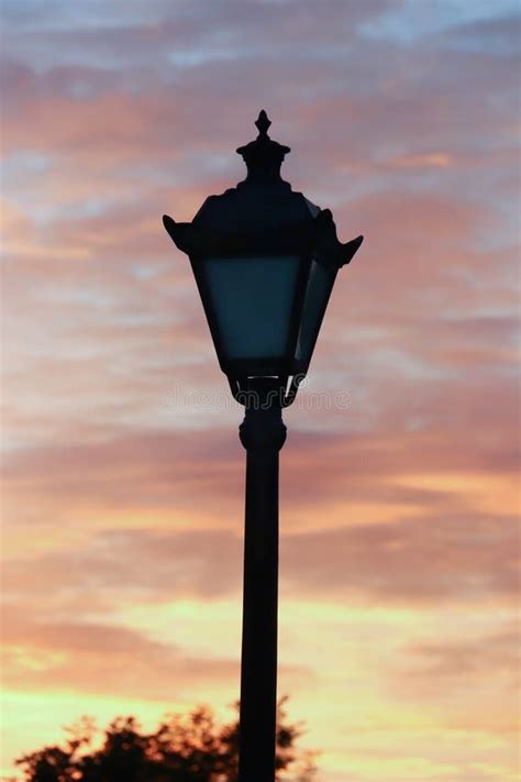 Silhouette Of A Lantern In The Light Of The Sunset In Millennium Stock