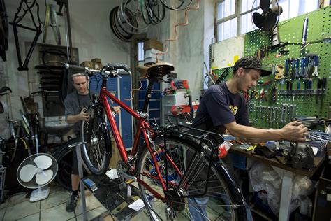 Filemunich Two Men Working In A Bicycle Repair Shop 5893