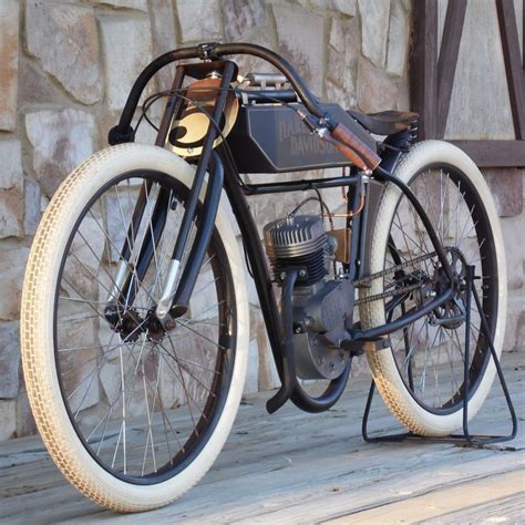 An Old Fashioned Motorcycle Parked On A Wooden Platform