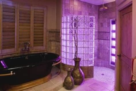 The purple plays well against the white of the bathroom vanity and wall lighting. Purple Bathroom Vanity Lighting Ideas 24