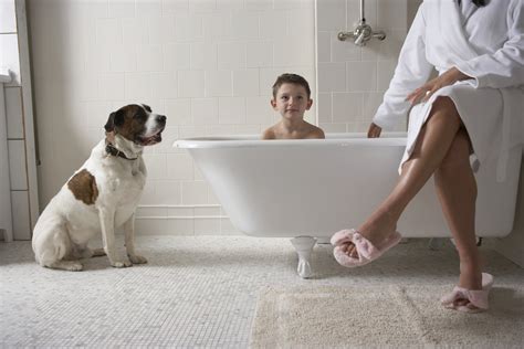 Mother Sitting On Side Of Tub With Son 6 8 In Bath Tub And With Dog