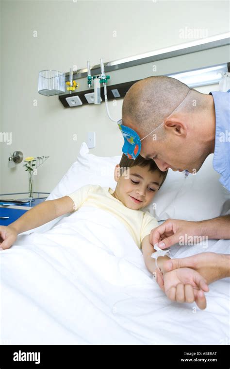 Boy Lying In Hospital Bed Nurse Adjusting Iv Stock Photo Alamy