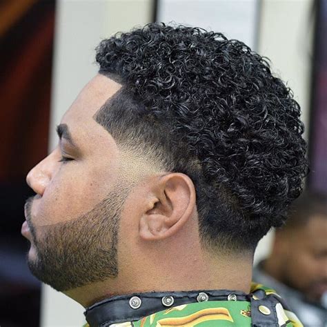The dense, short hair gives form to the cut. Mens Afro Hairstyles With Tight Curls