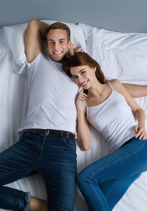 Young Happy Couple On The Bed In Love Relationship Dating Happy