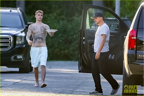 justin bieber goes shirtless in low hanging shorts while bringing a sandwich to his assistant