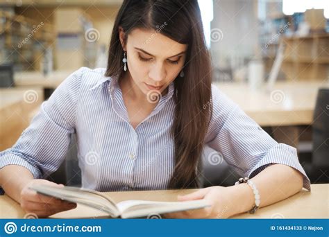 Young Woman Reading Book In Public Library Stock Image Image Of Group