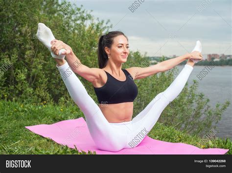 Woman Holding Legs Apart Doing Image Photo Bigstock